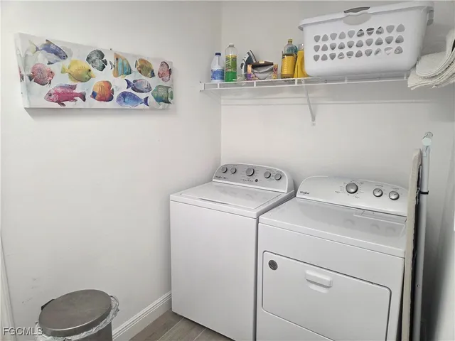 a kitchen with granite countertop white cabinets and stainless steel appliances