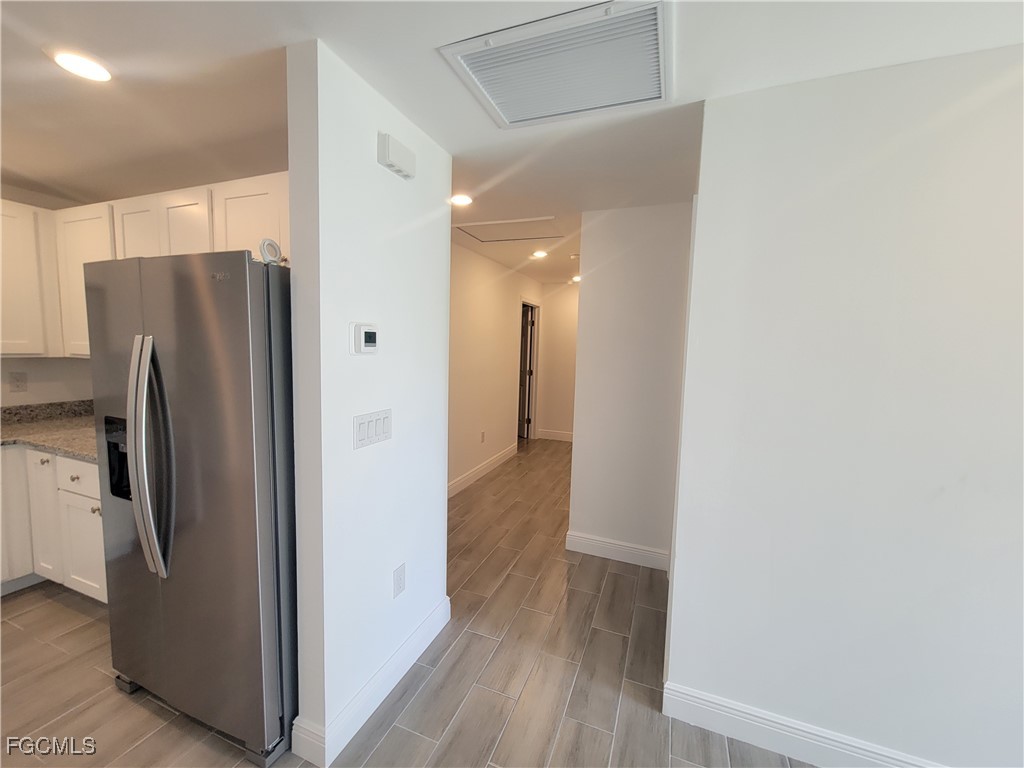 2156-2154 Edison Avenue Fort Myers, FL 33901 - Photo 18 of 38 a view of a refrigerator in kitchen and wooden floor