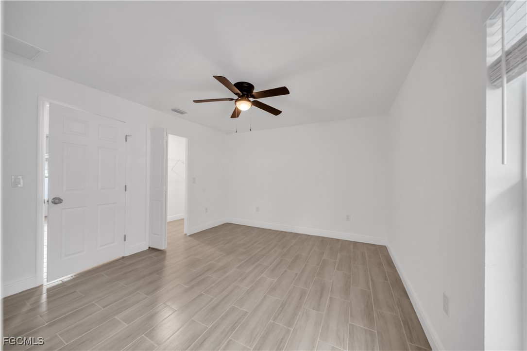 2156-2154 Edison Avenue Fort Myers, FL 33901 - Photo 22 of 38 wooden floor in an empty room with a window