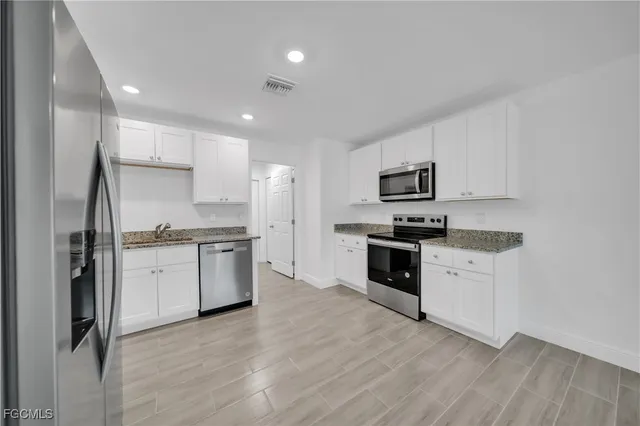 an aerial view of residential houses with outdoor space and river