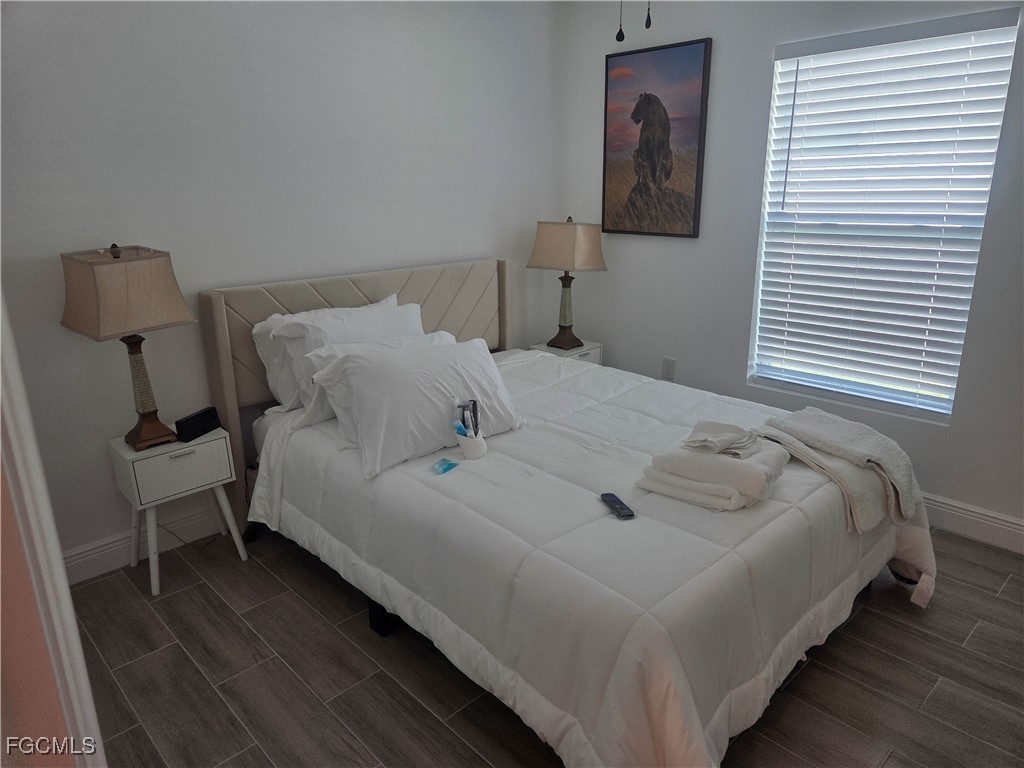 2156-2154 Edison Avenue Fort Myers, FL 33901 - Photo 26 of 38 a bed sitting in a bedroom next to a window