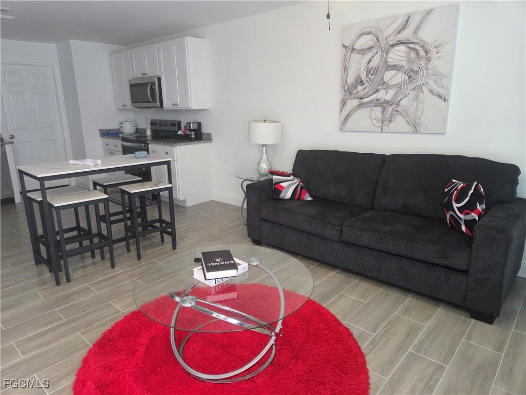 2156-2154 Edison Avenue Fort Myers, FL 33901 - Photo 7 of 38 a living room with furniture and a wooden floor