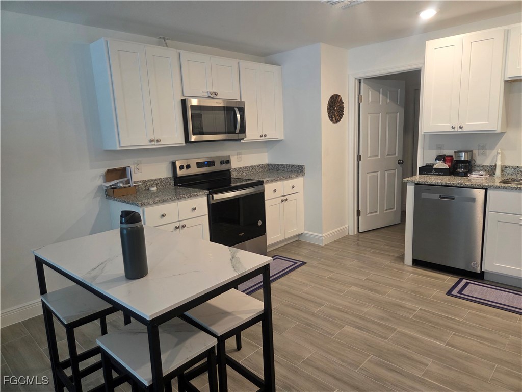2156-2154 Edison Avenue Fort Myers, FL 33901 - Photo 9 of 38 a kitchen with a stove a sink and a refrigerator
