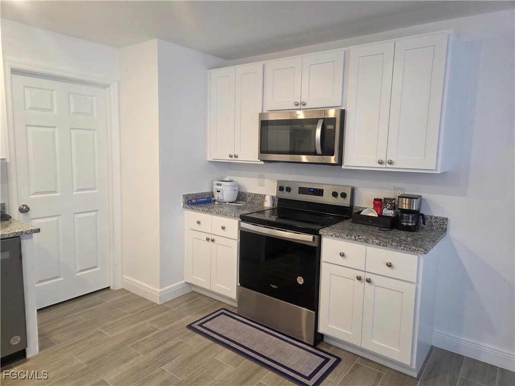 2156-2154 Edison Avenue Fort Myers, FL 33901 - Photo 10 of 38 a kitchen with granite countertop white cabinets sink and stainless steel appliances