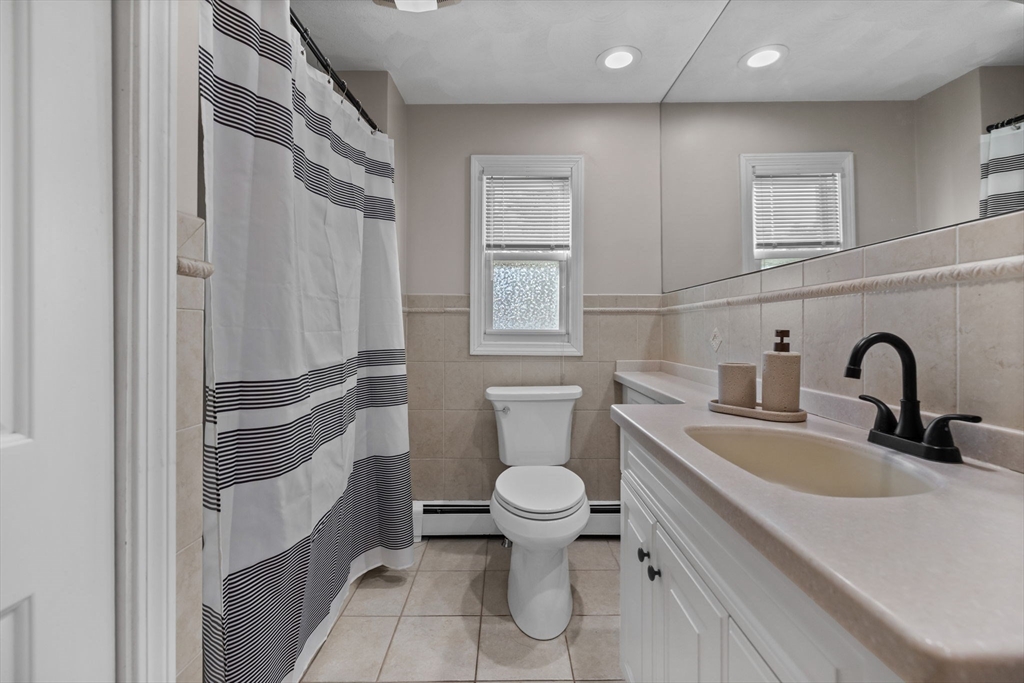 201 Water Street Saugus, MA 01906 - Photo 14 of 38 a bathroom with a granite countertop toilet sink and mirror