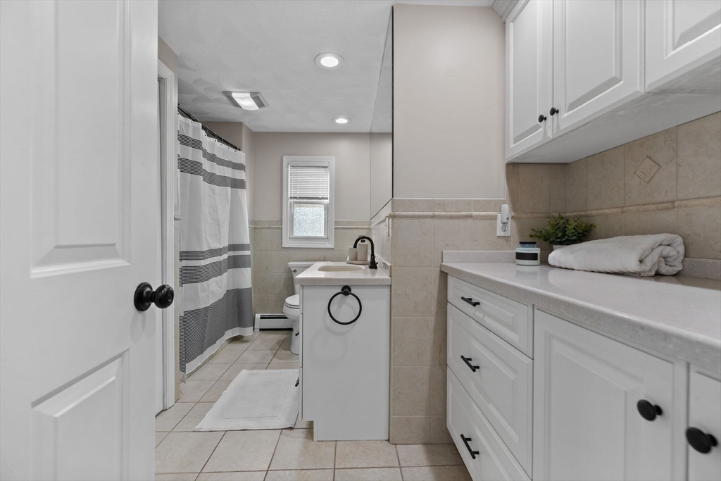 201 Water Street Saugus, MA 01906 - Photo 15 of 38 a bathroom with a sink mirror and vanity