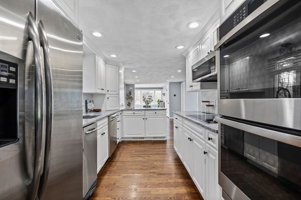 201 Water Street Saugus, MA 01906 - Photo 8 of 38 a kitchen with stainless steel appliances granite countertop a refrigerator and a sink