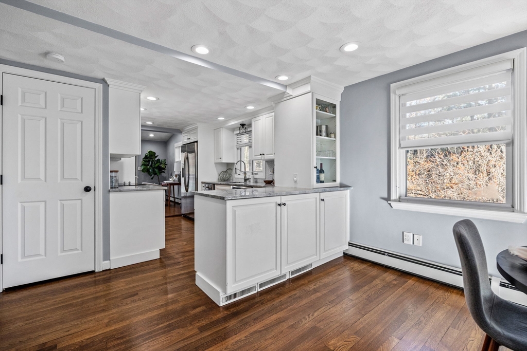 201 Water Street Saugus, MA 01906 - Photo 9 of 38 a kitchen with a wooden floor and white appliances