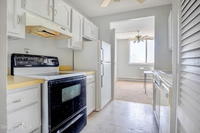 a kitchen with stainless steel appliances granite countertop a stove and a refrigerator