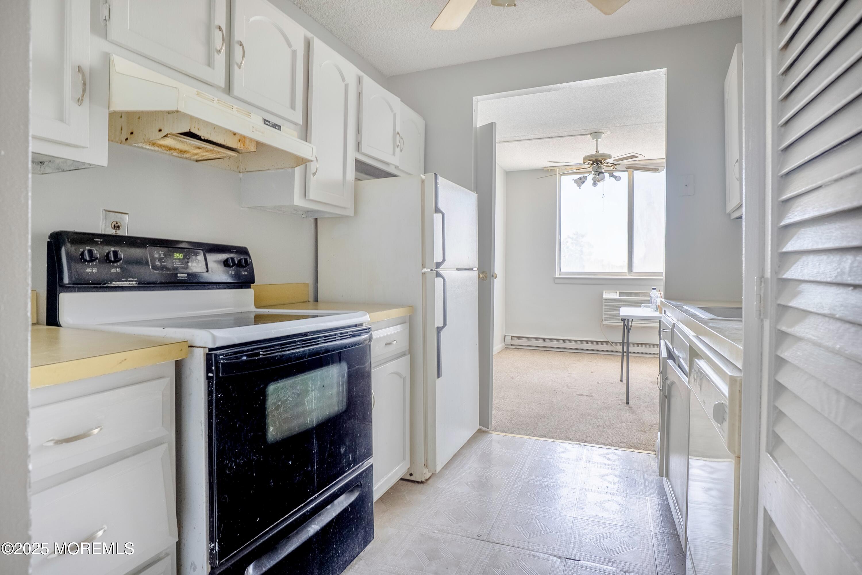 1000 River Road, Unit 4G Belmar, NJ 07719 - Photo 6 of 13 a kitchen with stainless steel appliances granite countertop a stove and a refrigerator