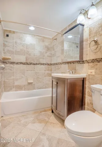 a bathroom with a sink a toilet and bathtub