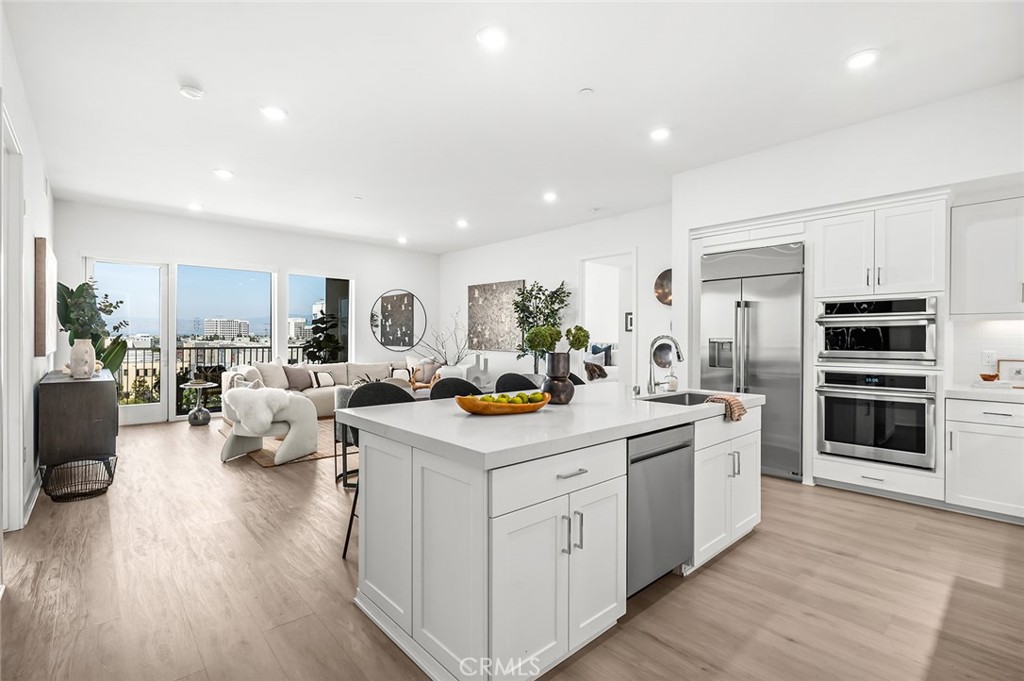 3604 Rivington Irvine, CA 92612 - Photo 2 of 54 a kitchen that has a lot of cabinets a sink and wooden floor