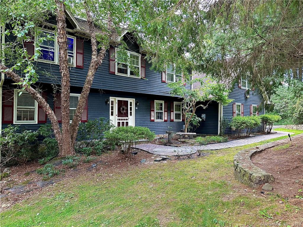 a front view of a house with garden and porch
