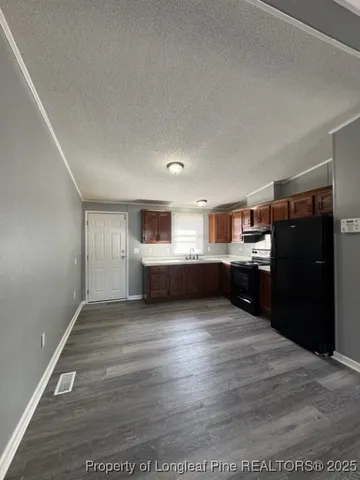 a view of a kitchen with cabinets and stainless steel appliances