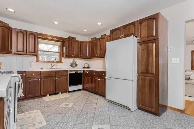 a kitchen with a refrigerator a sink and cabinets