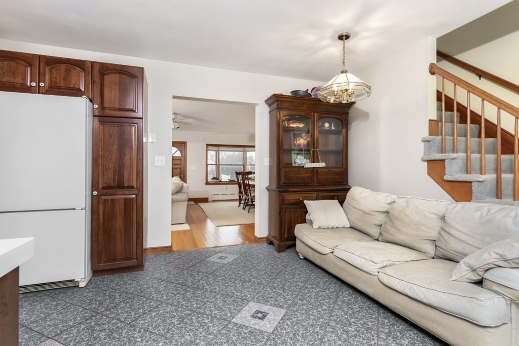 8 Castle Road Nahant, MA 01908 - Photo 12 of 32 a living room with furniture a refrigerator and a chandelier