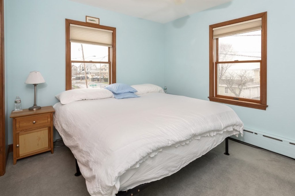8 Castle Road Nahant, MA 01908 - Photo 15 of 32 a large bed sitting in a bedroom next to a window