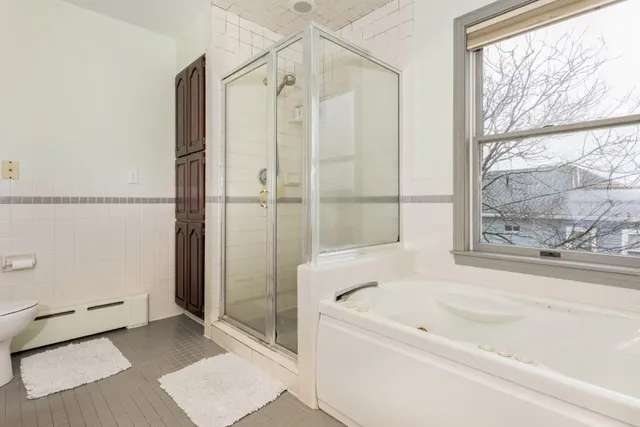 a bathroom with a bathtub and a shower