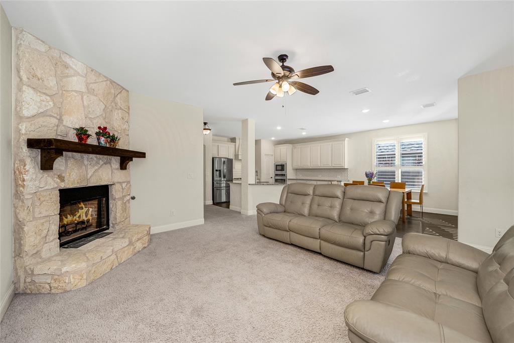 2203 Vista Ridge Road Melissa, TX 75454 - Photo 11 of 40 Living room with light colored carpet, a fireplace, ceiling fan, and recessed lighting