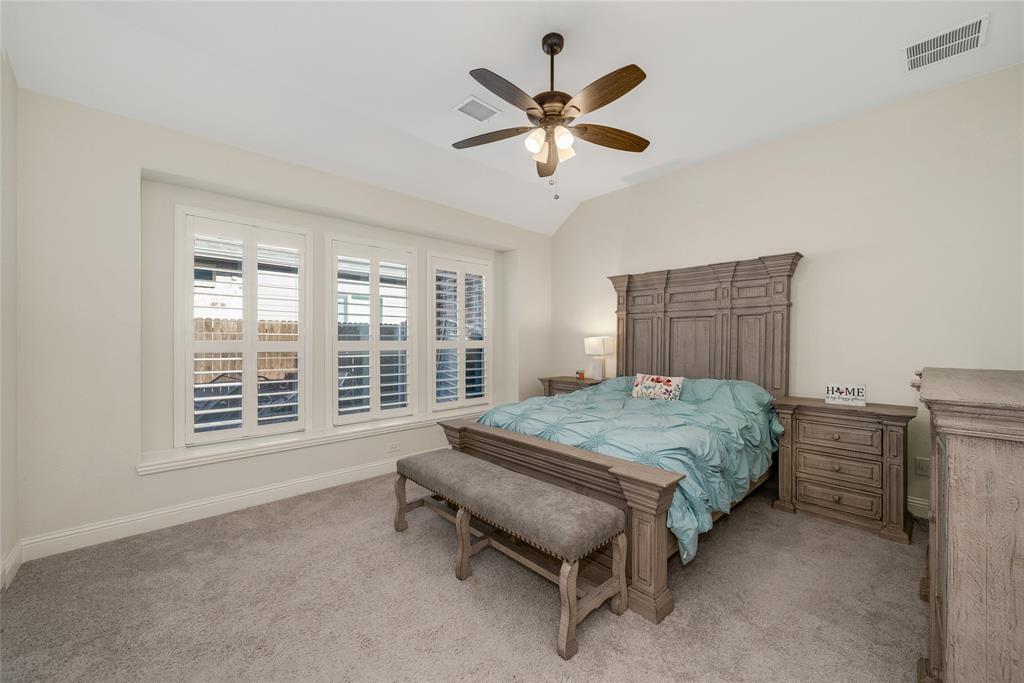 2203 Vista Ridge Road Melissa, TX 75454 - Photo 14 of 40 Bedroom featuring a ceiling fan, light carpet, and vaulted ceiling