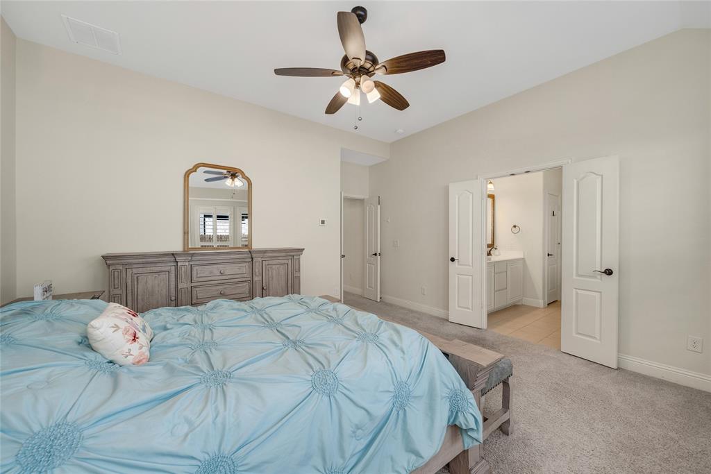 2203 Vista Ridge Road Melissa, TX 75454 - Photo 16 of 40 Bedroom featuring light carpet, a ceiling fan, and connected bathroom