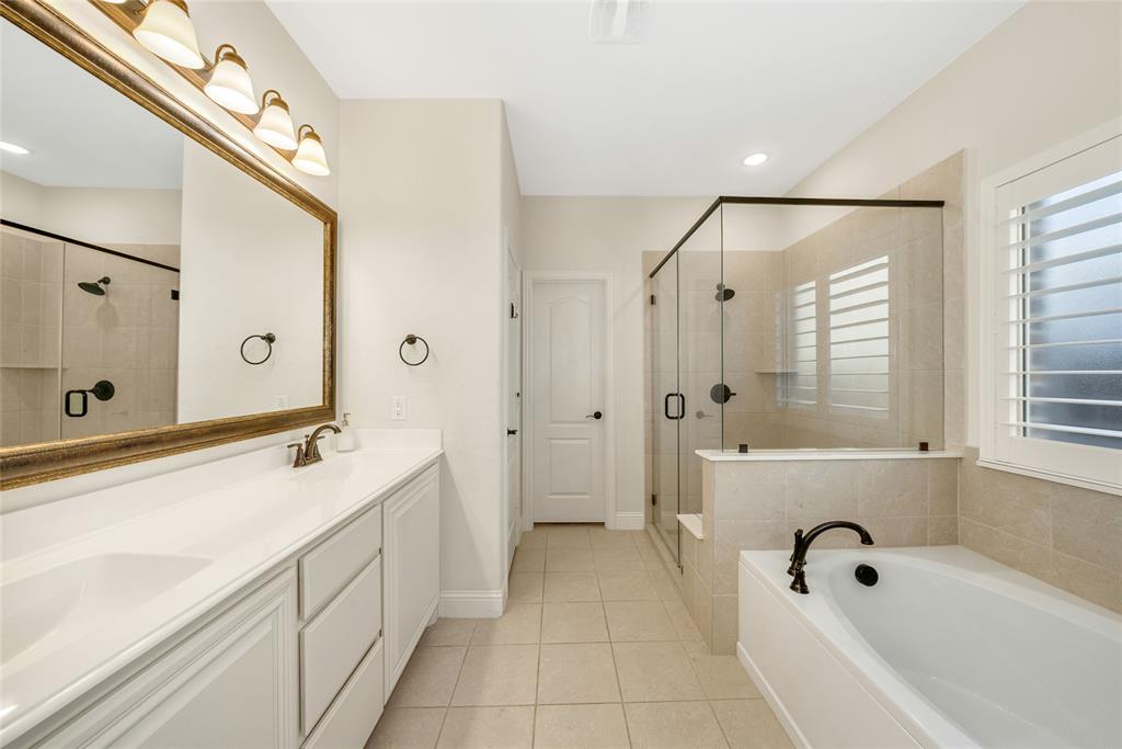 2203 Vista Ridge Road Melissa, TX 75454 - Photo 17 of 40 Full bathroom featuring double vanity, a bath, light tile patterned flooring, and a stall shower