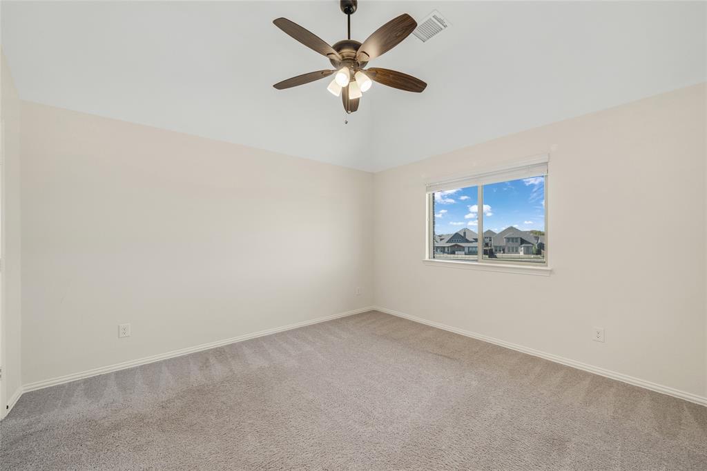 2203 Vista Ridge Road Melissa, TX 75454 - Photo 24 of 40 Spare room featuring light colored carpet, ceiling fan, and vaulted ceiling