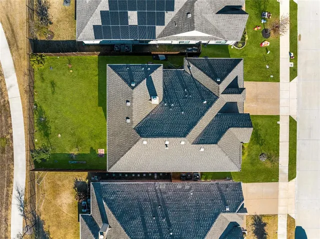 an aerial view of a house with a yard