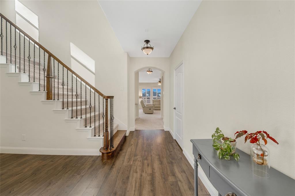 2203 Vista Ridge Road Melissa, TX 75454 - Photo 6 of 40 Foyer entrance with arched walkways, stairway, and dark wood-style flooring