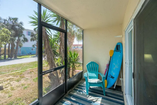 a view of a house with a yard and potted plants
