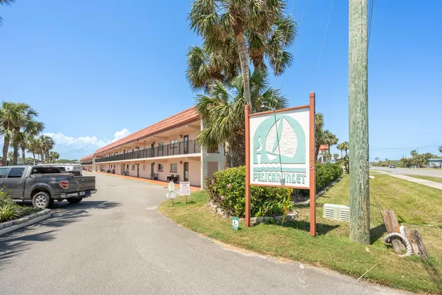 a view of a house with backyard and porch