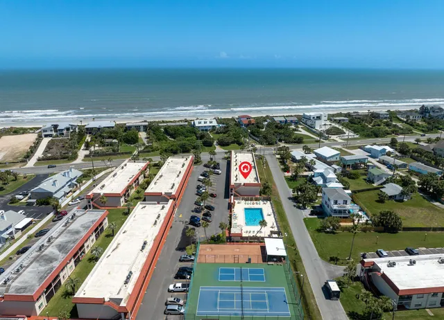 an aerial view of a houses with a yard