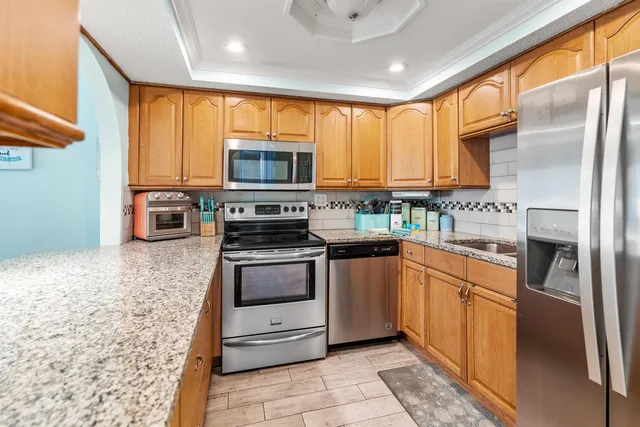 a kitchen with stainless steel appliances granite countertop a stove and cabinets