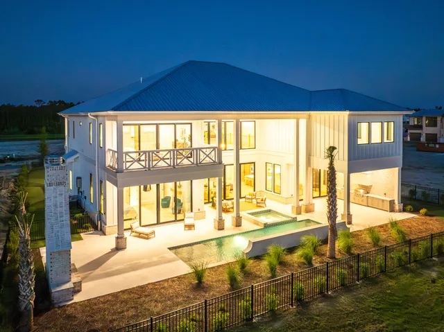 a living room with furniture a fireplace and a large window