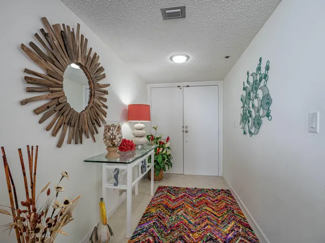 a view of a dining room with furniture a chandelier and wooden floor