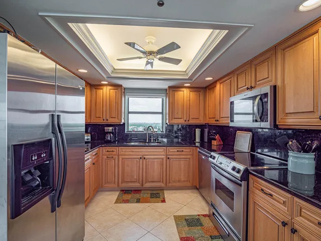 a bedroom with double bed and a chandelier