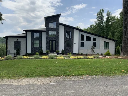 a view of a green field with lots of bushes