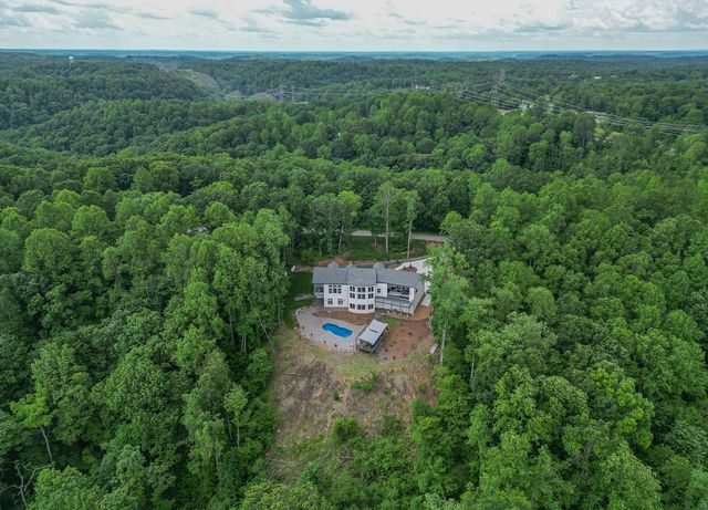 an aerial view of a house with a yard and trees
