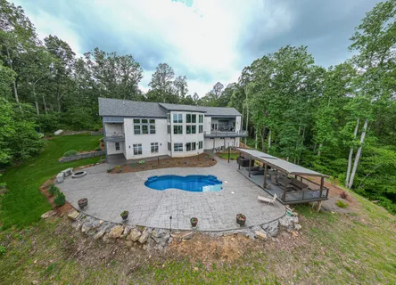 an aerial view of a house with outdoor space patio and trees