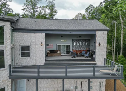 an aerial view of a house with a yard and trees
