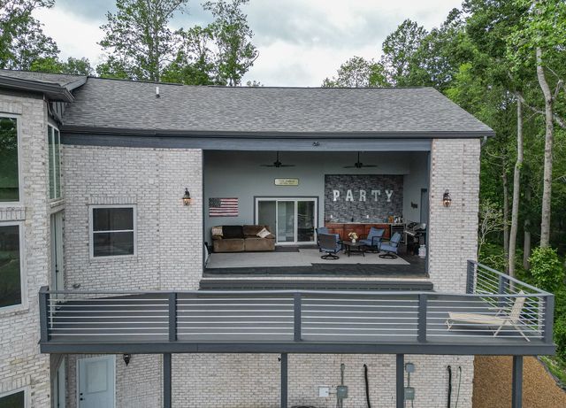 an aerial view of a house with a yard and trees