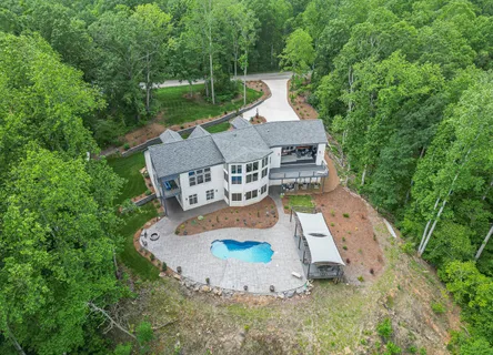 an aerial view of a house with a yard