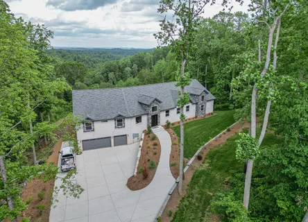 a view of a house with a yard and tree s