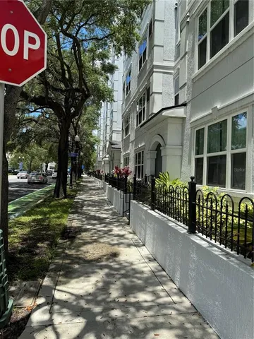 a view of a street with houses and trees