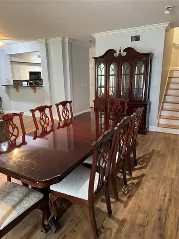 a living room with furniture a flat screen tv and a window