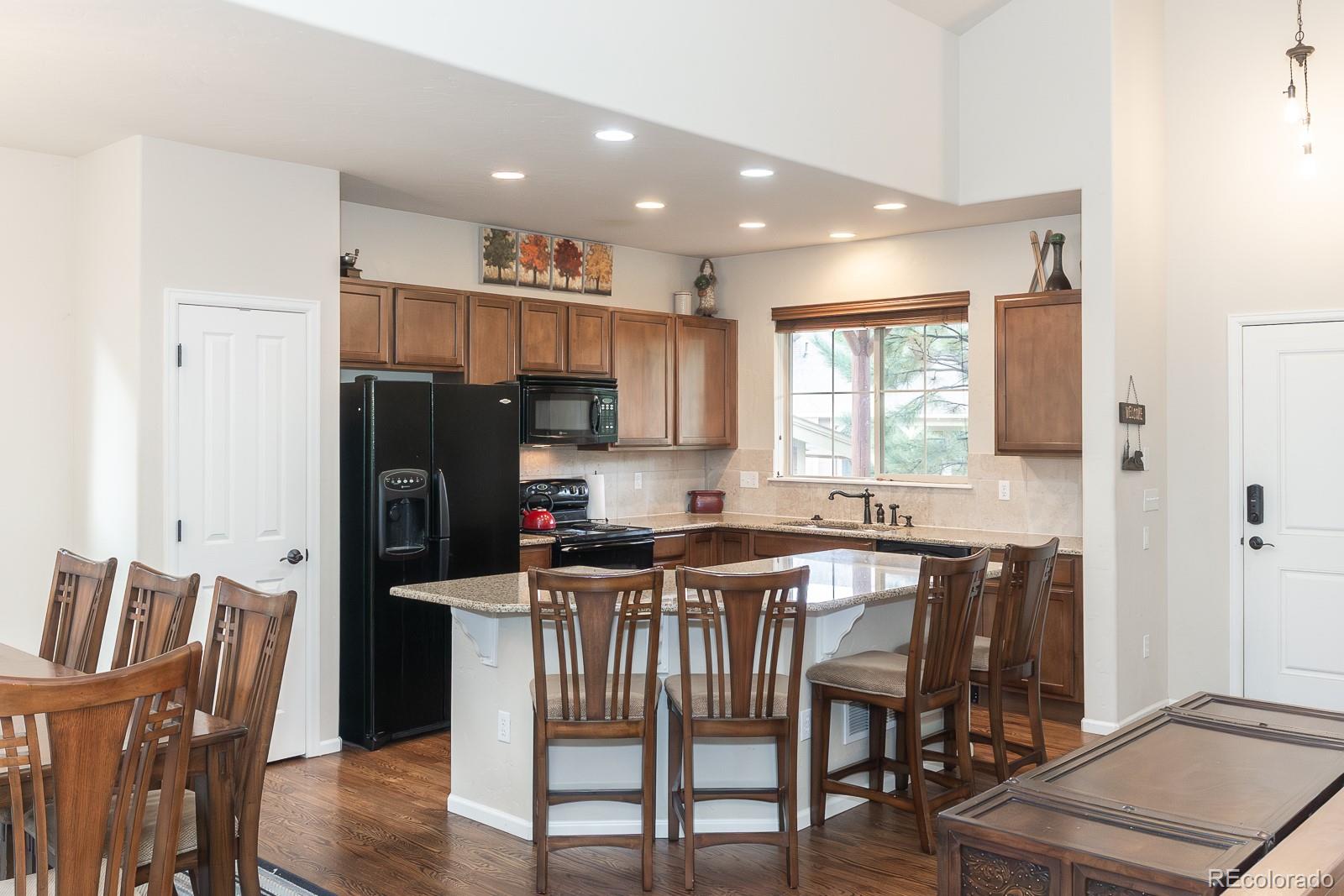 103 Timber Court Granby, CO 80446 - Photo 14 of 50 a kitchen with stainless steel appliances granite countertop a table chairs refrigerator a sink and dishwasher