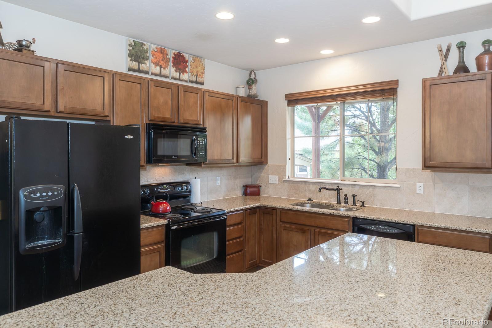 103 Timber Court Granby, CO 80446 - Photo 16 of 50 a kitchen with granite countertop a sink stainless steel appliances and cabinets