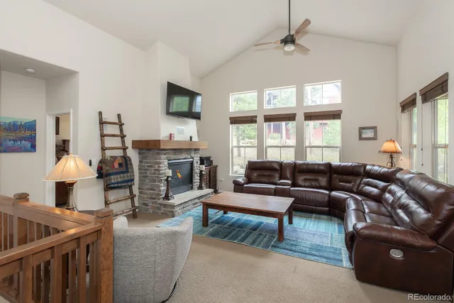 a living room with furniture a fireplace and a flat screen tv