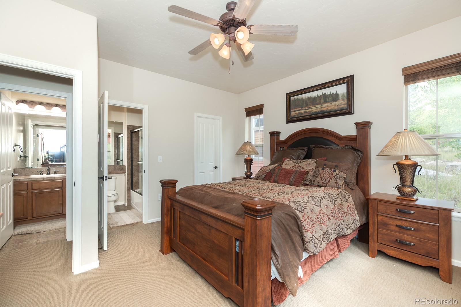 103 Timber Court Granby, CO 80446 - Photo 27 of 50 a bedroom with a bed and a chandelier