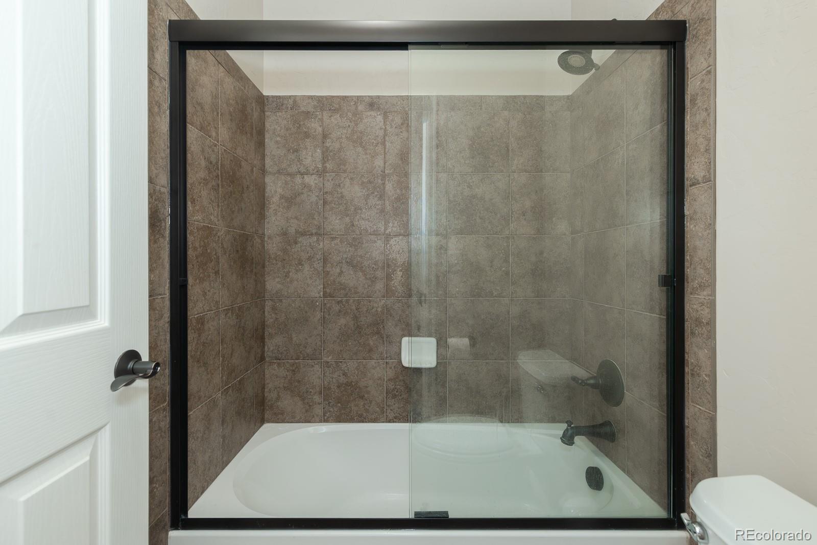 103 Timber Court Granby, CO 80446 - Photo 32 of 50 a bathroom with a shower and toilet